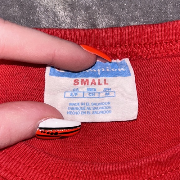 This is a champion shirt. True to its size, it’s a small. The color is red. - Picture 3 of 4
